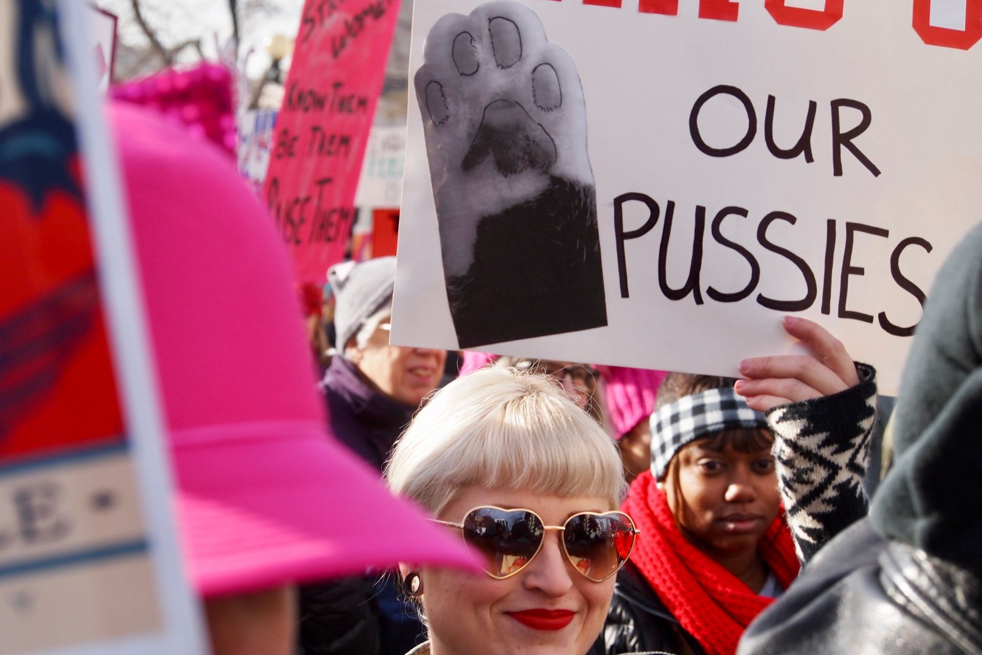 photography, featuring women on the streets, using signs in some way